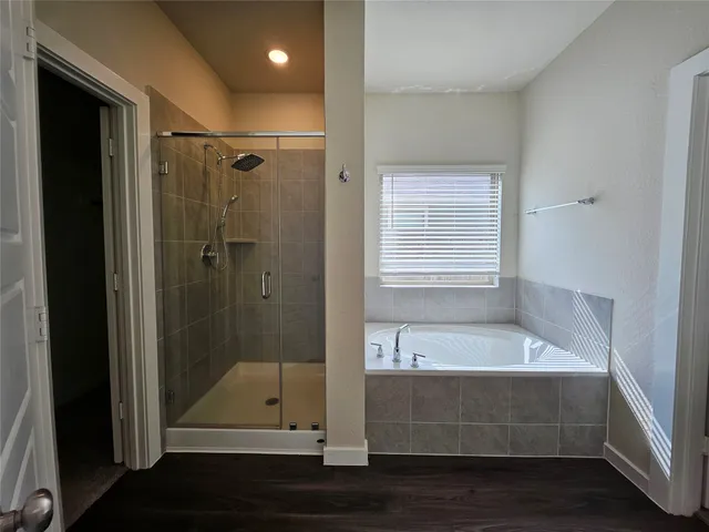 a bathroom with a tub and shower