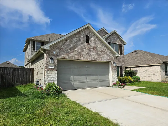 a front view of a house with a yard and garage