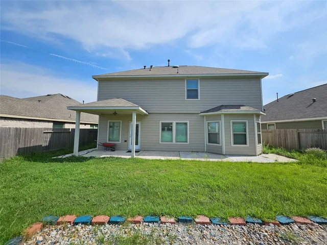 a view of a house with a yard and sitting area