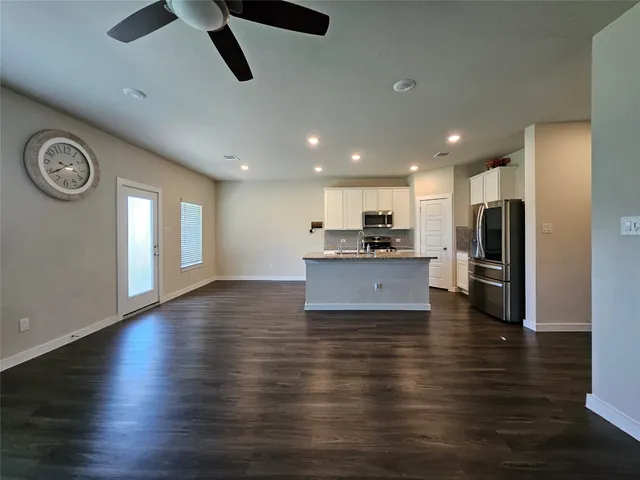 a large kitchen with stainless steel appliances granite countertop a stove and a refrigerator