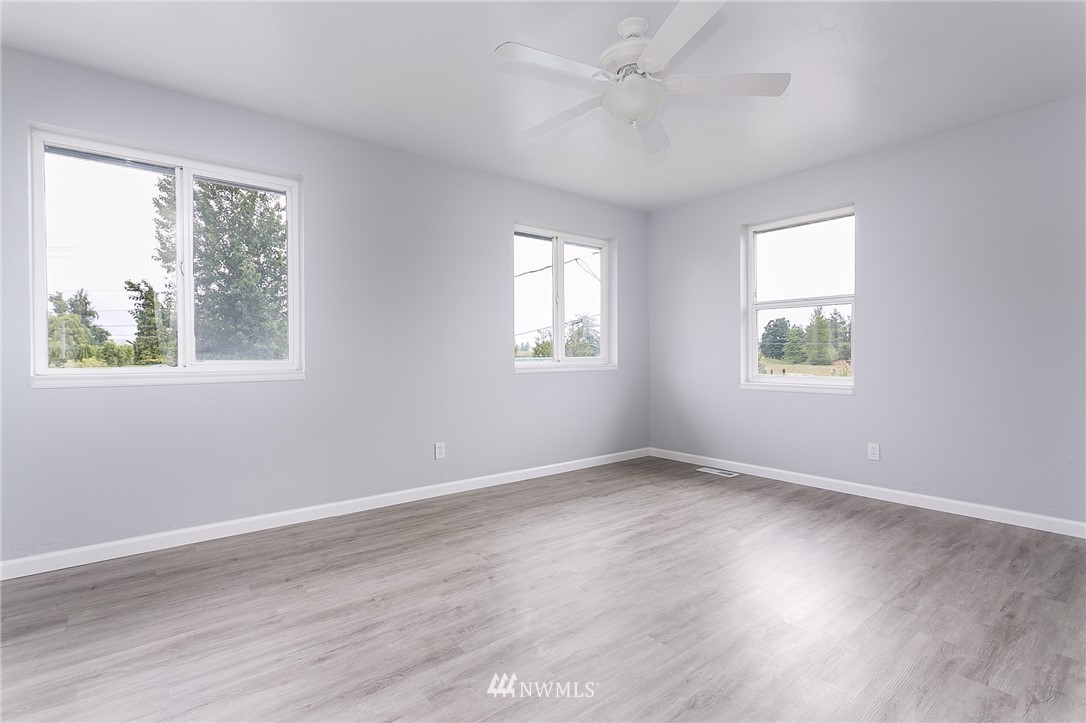 2419 East Badger Road Everson, WA 98247 - Photo 14 of 34 a view of an empty room with wooden floor and a window