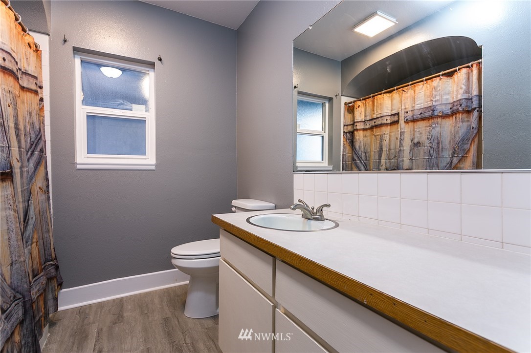 2419 East Badger Road Everson, WA 98247 - Photo 20 of 34 a bathroom with a sink a toilet and mirror