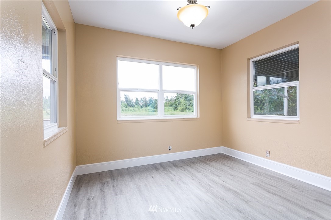 2419 East Badger Road Everson, WA 98247 - Photo 21 of 34 a view of wooden floor and windows in a room