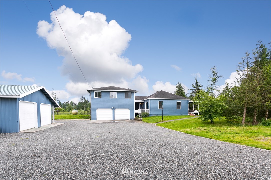 2419 East Badger Road Everson, WA 98247 - Photo 29 of 34 a view of a house next to a yard and large trees