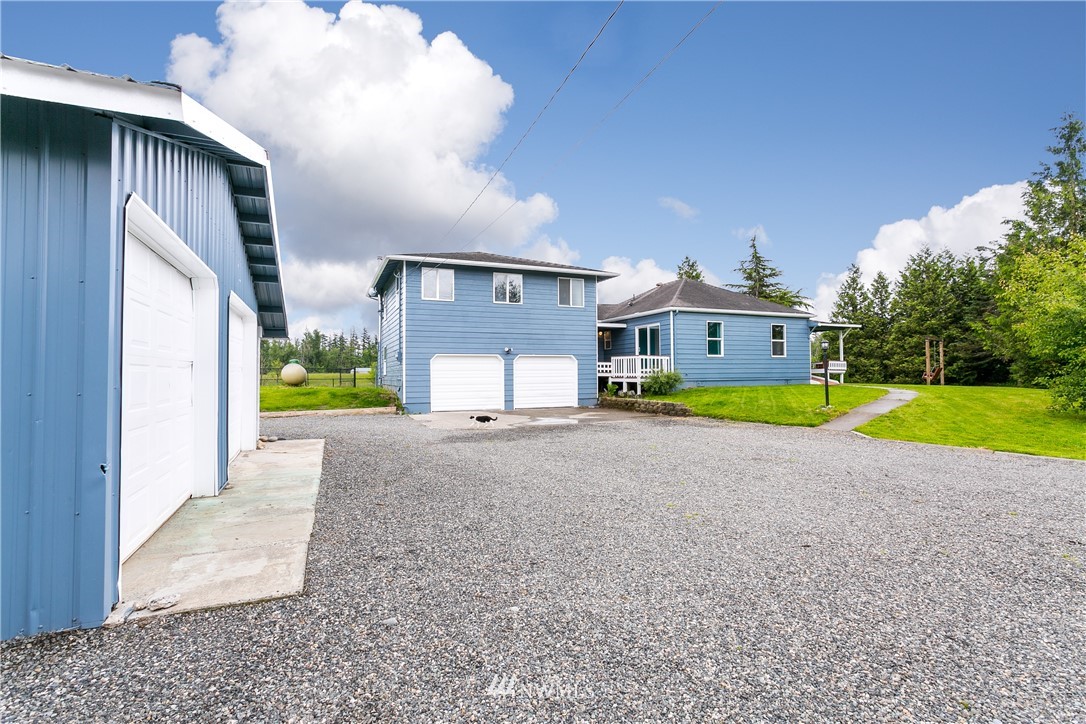 2419 East Badger Road Everson, WA 98247 - Photo 30 of 34 a view of a house with a swimming pool and a yard
