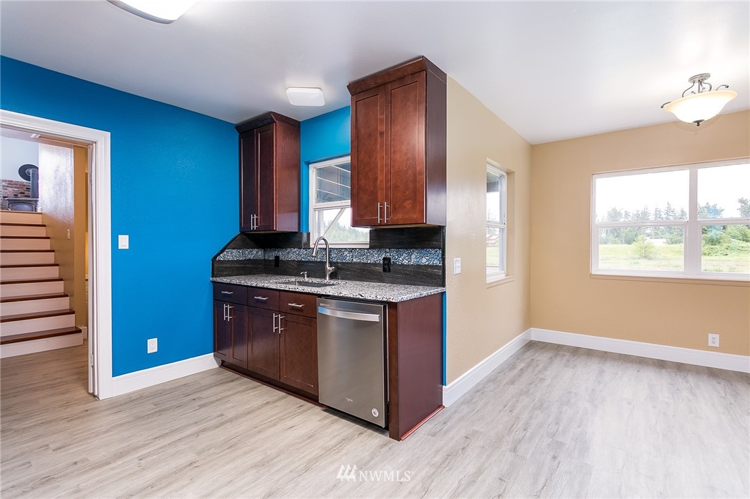 2419 East Badger Road Everson, WA 98247 - Photo 7 of 34 a kitchen with stainless steel appliances granite countertop a stove a sink and a refrigerator