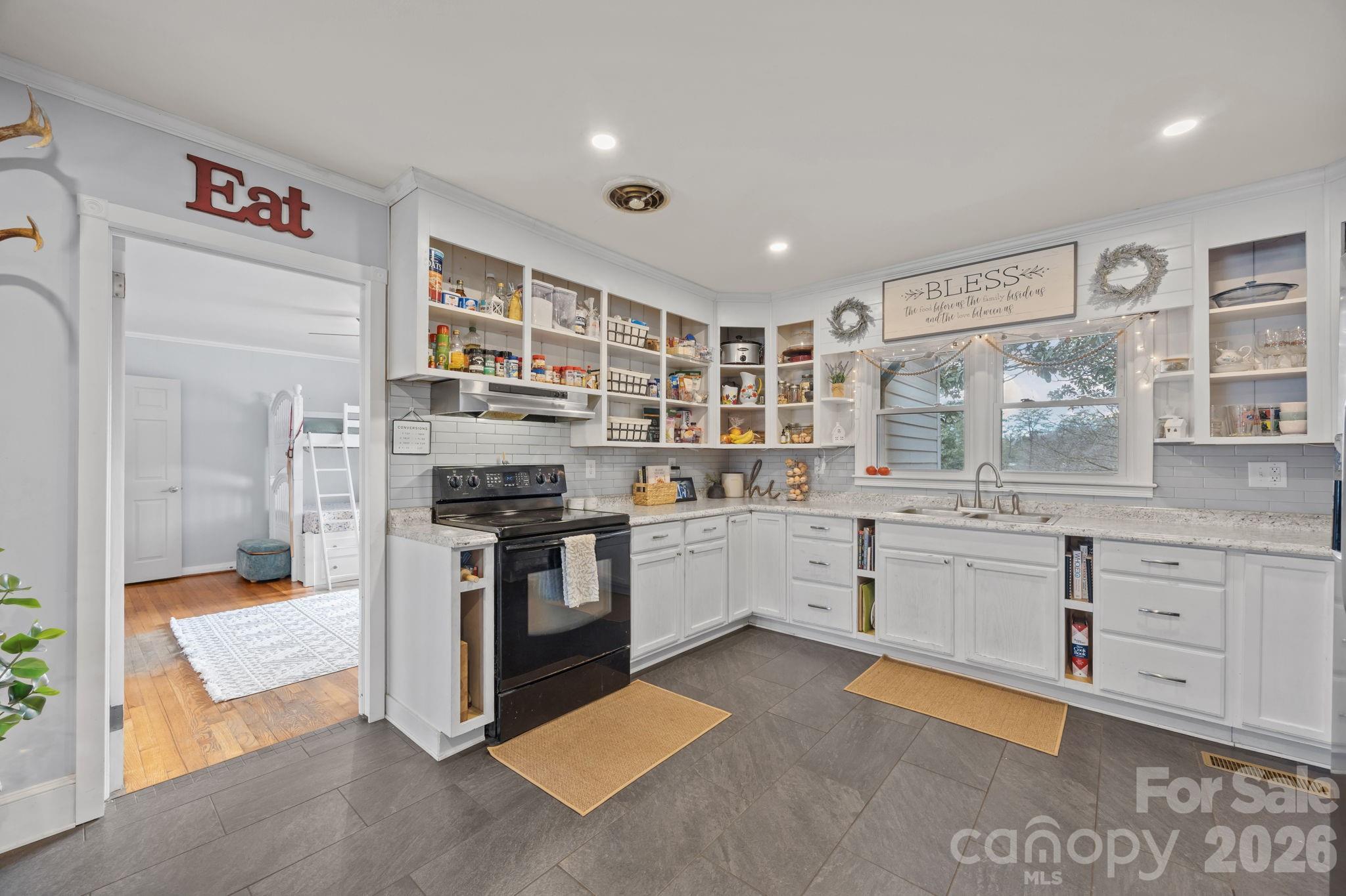 275 Tanner Street Rutherfordton, NC 28139 - Photo 24 of 44 a kitchen with stainless steel appliances granite countertop a stove and a sink