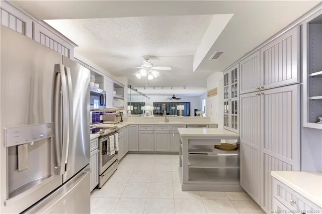 a kitchen with cabinets and refrigerator