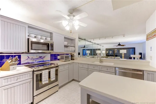 a kitchen with a stove and a white cabinets