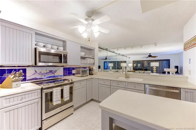 a kitchen with a stove and a white cabinets