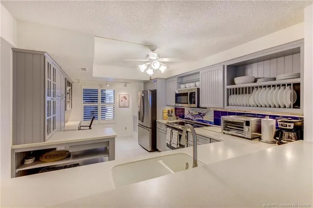 a living room with furniture a flat screen tv and white walls