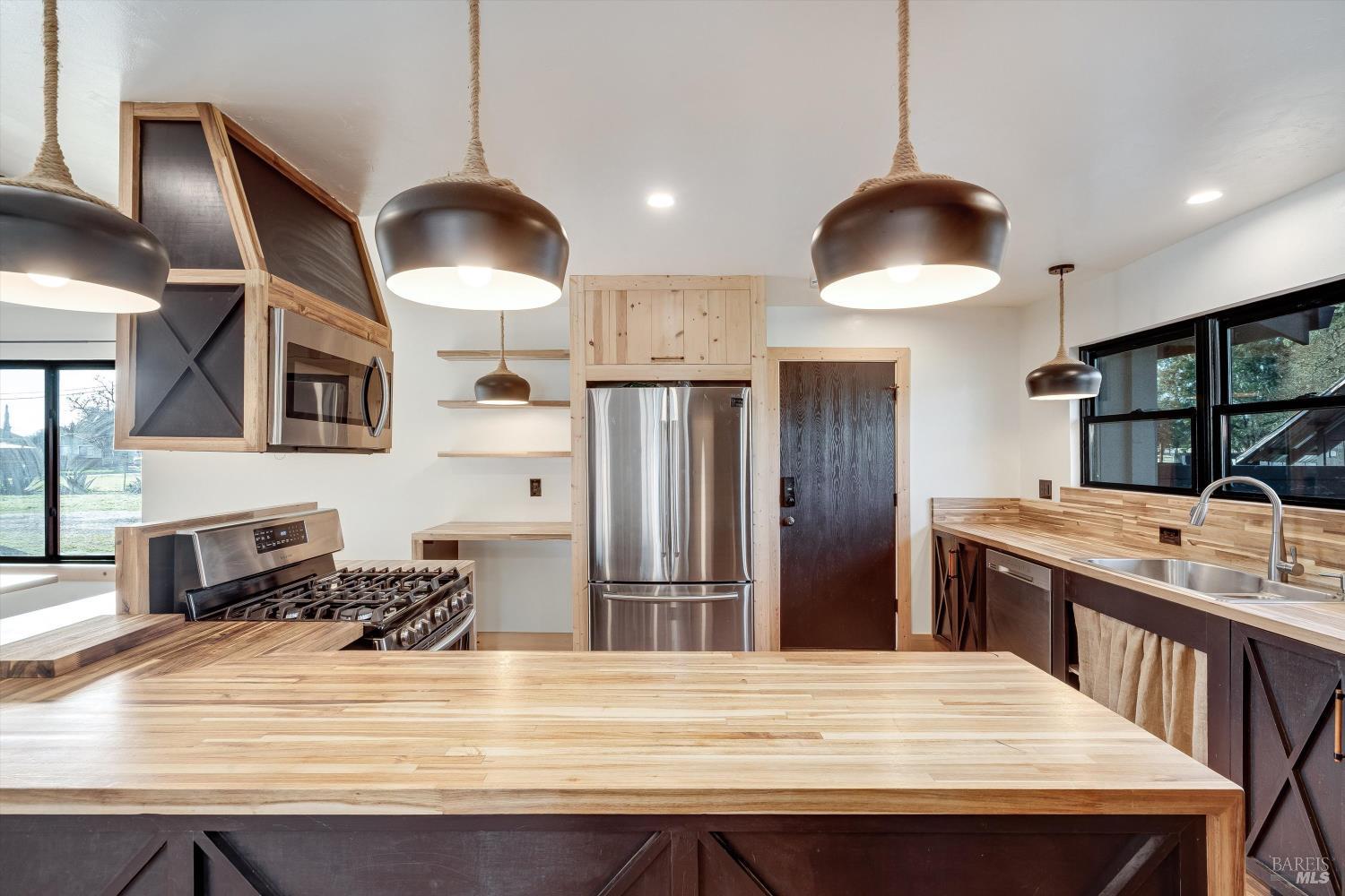985 Gumview Road Windsor, CA 95492 - Photo 11 of 48 a kitchen with stainless steel appliances granite countertop a sink a stove and refrigerator