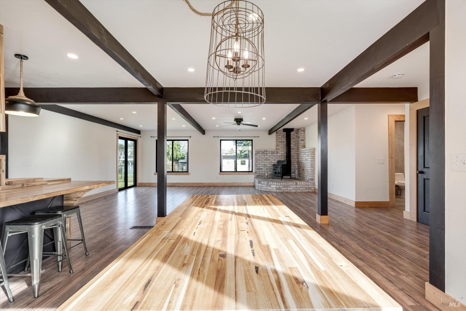 985 Gumview Road Windsor, CA 95492 - Photo 16 of 48 a view of a hallway with a dining table chairs and a chandelier