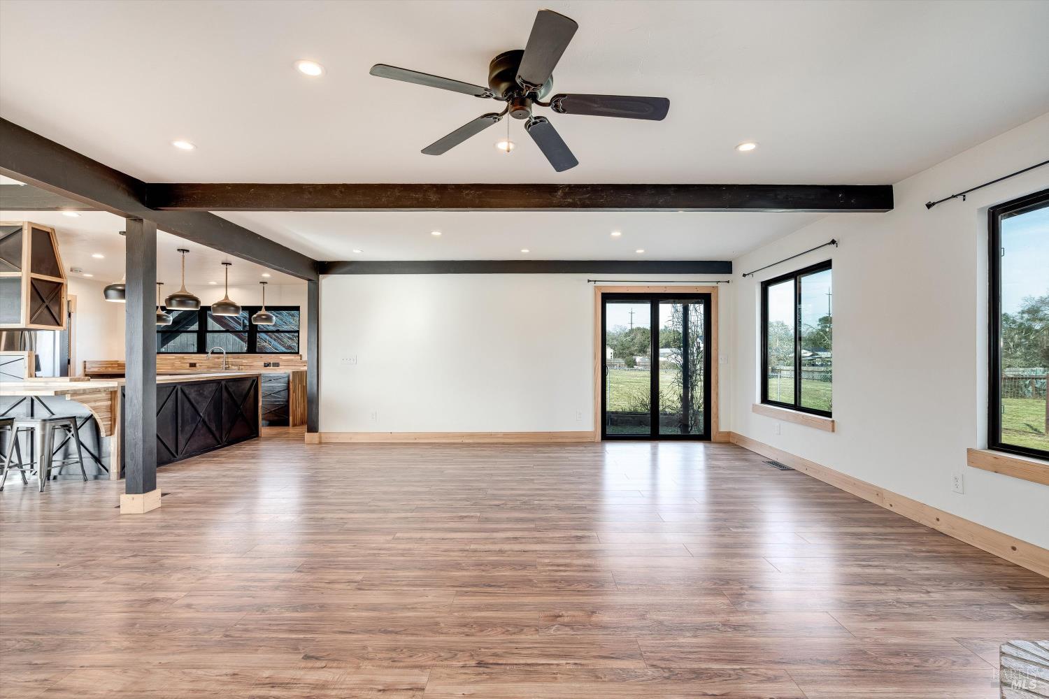 985 Gumview Road Windsor, CA 95492 - Photo 17 of 48 a view of an empty room with wooden floor and a window