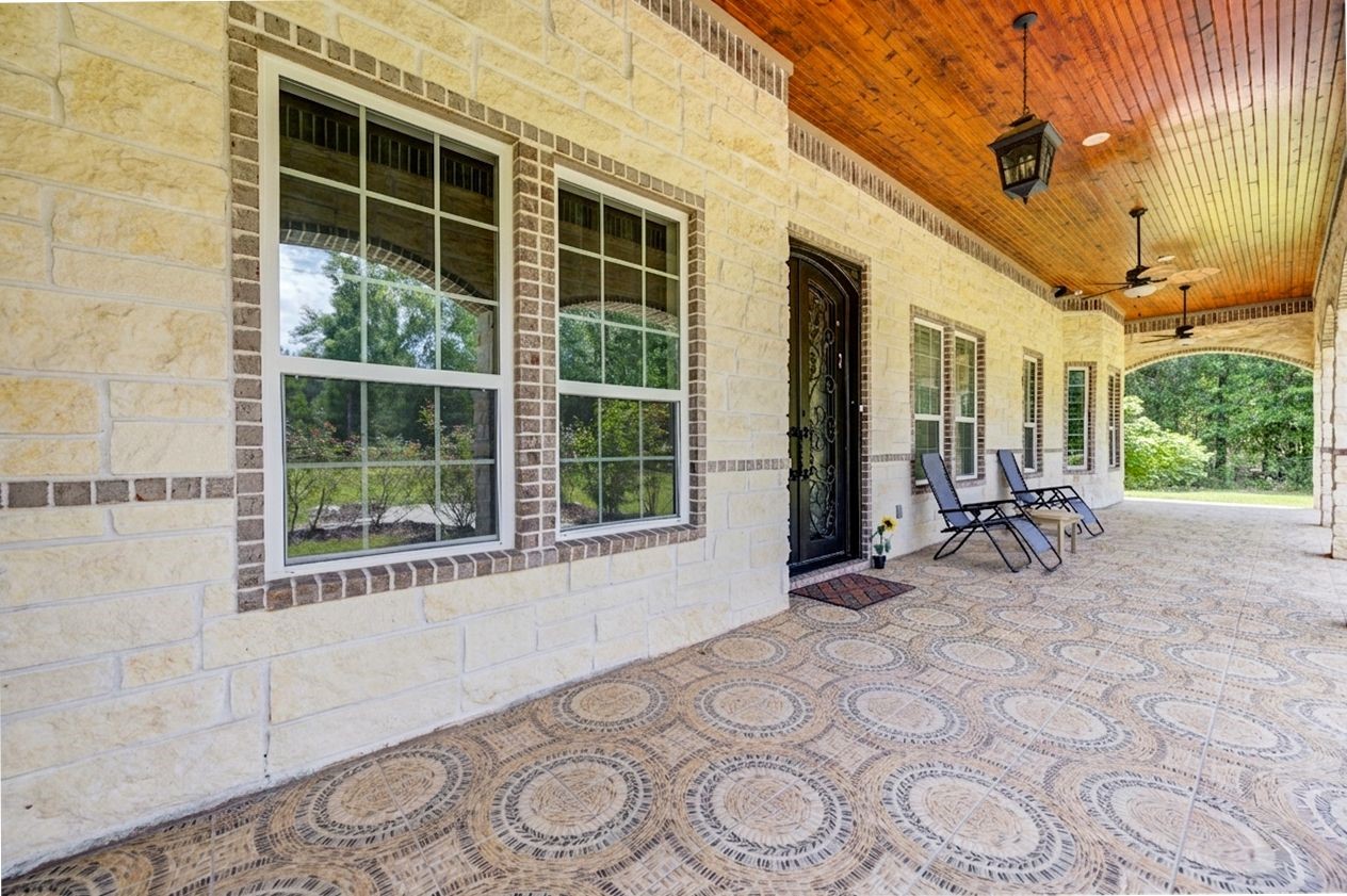 21038 Angus Drive Cleveland, TX 77328 - Photo 9 of 49 a view of a patio with table and chairs and potted plants