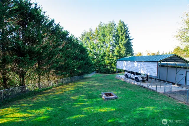 a view of a house with a yard and sitting area