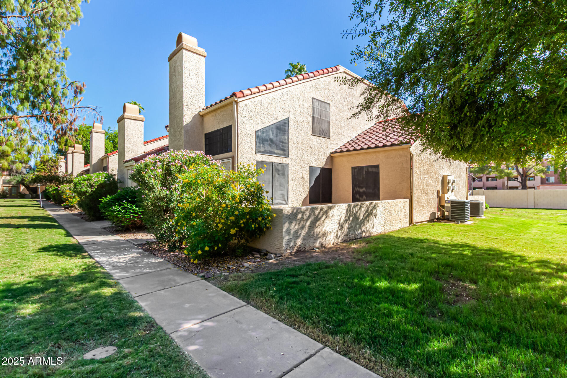 602 North May, Unit 49 Mesa, AZ 85201 - Photo 1 of 32 a front view of house with yard and green space