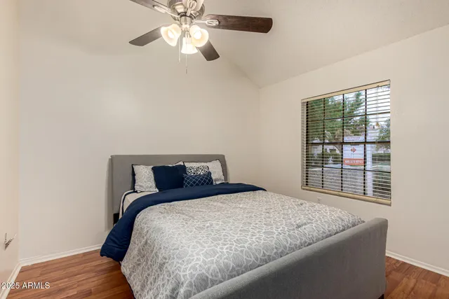 a bedroom with a bed and a window