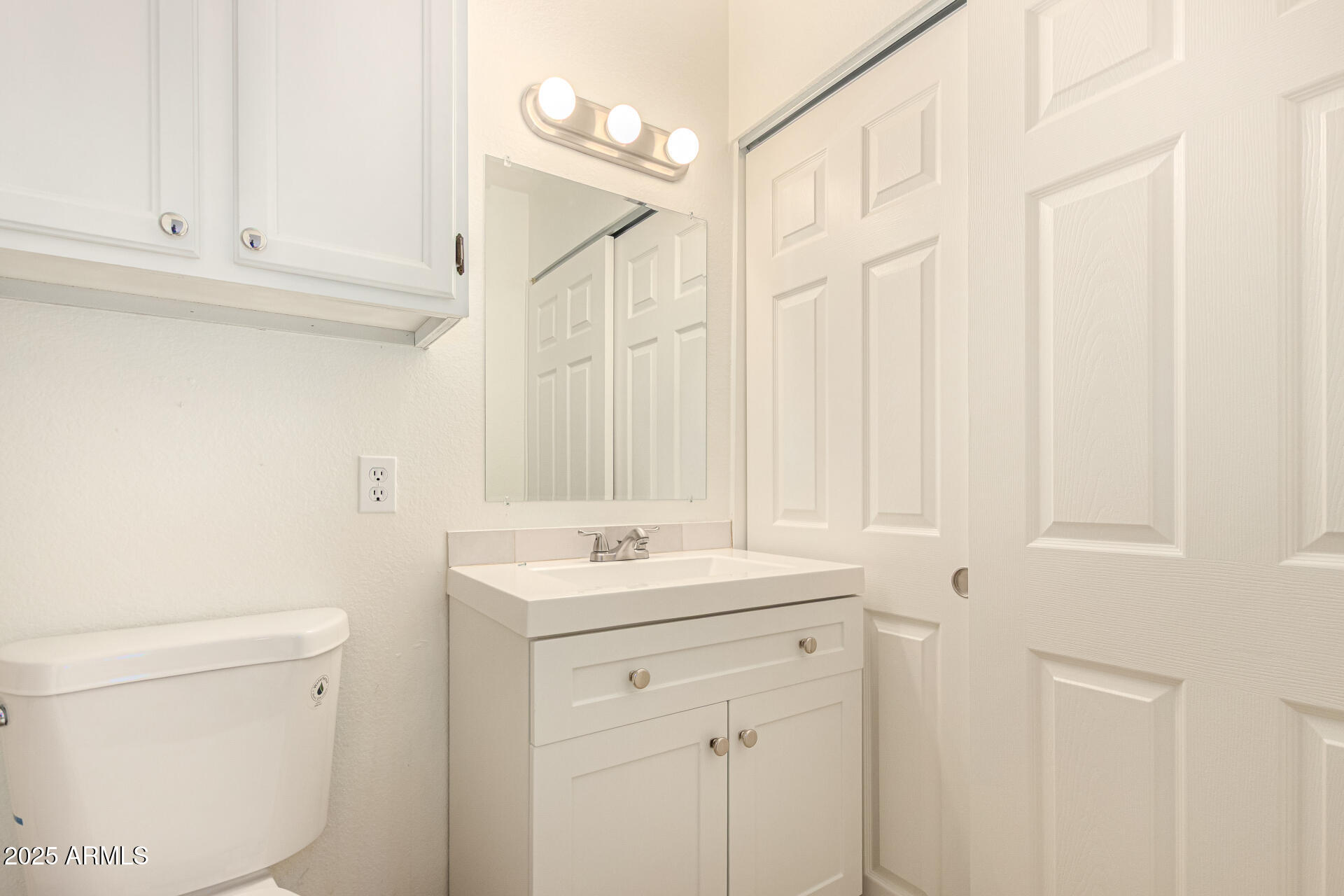 602 North May, Unit 49 Mesa, AZ 85201 - Photo 23 of 32 a bathroom with a sink a toilet and a mirror