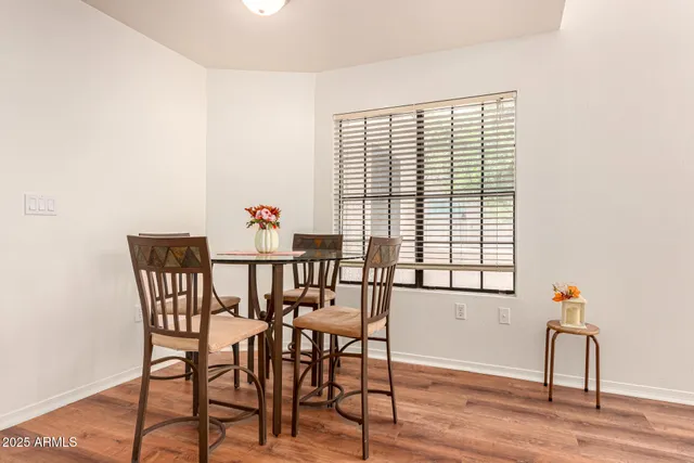 a view of a dining room with furniture window and wooden floor