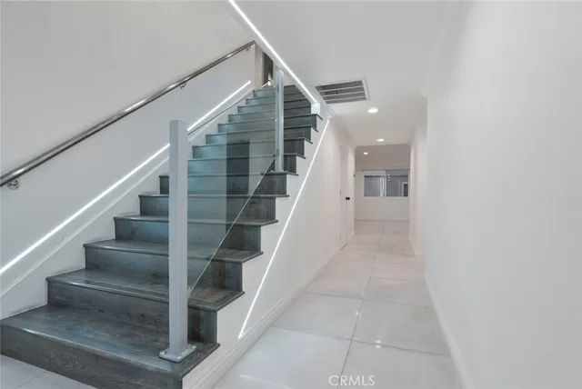 an empty room with wooden floor and bathroom