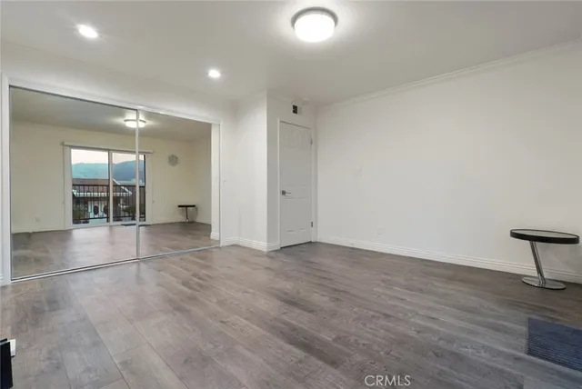 en empty room with wooden floor and furniture