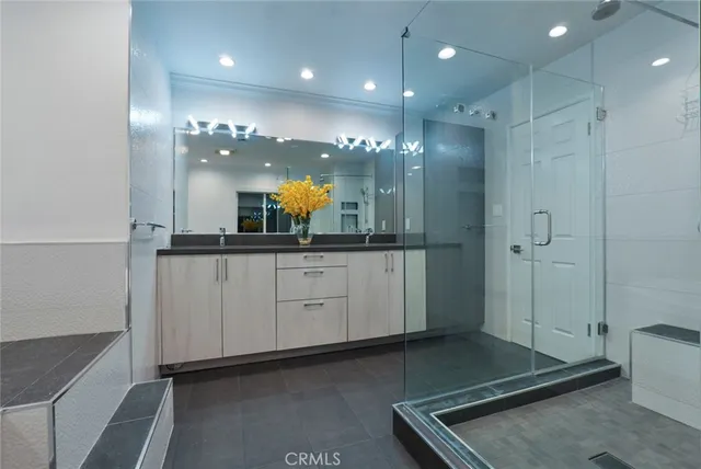 a bathroom with a granite countertop sink a toilet and shower