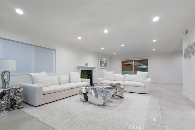 a living room with furniture and kitchen view