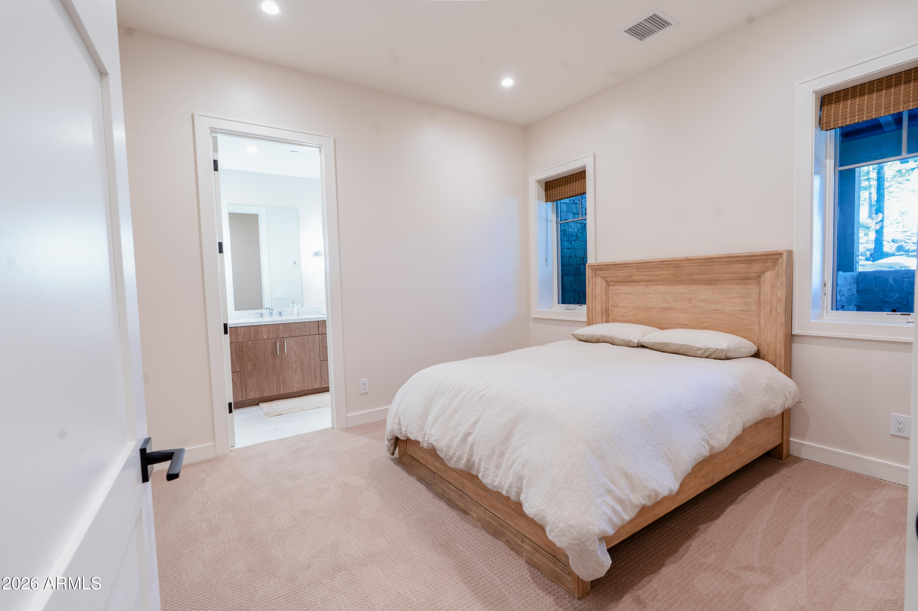 1733 East Bent Tree Circle, Unit 45 Flagstaff, AZ 86005 - Photo 17 of 37 a bedroom with a bed and closet with mirror