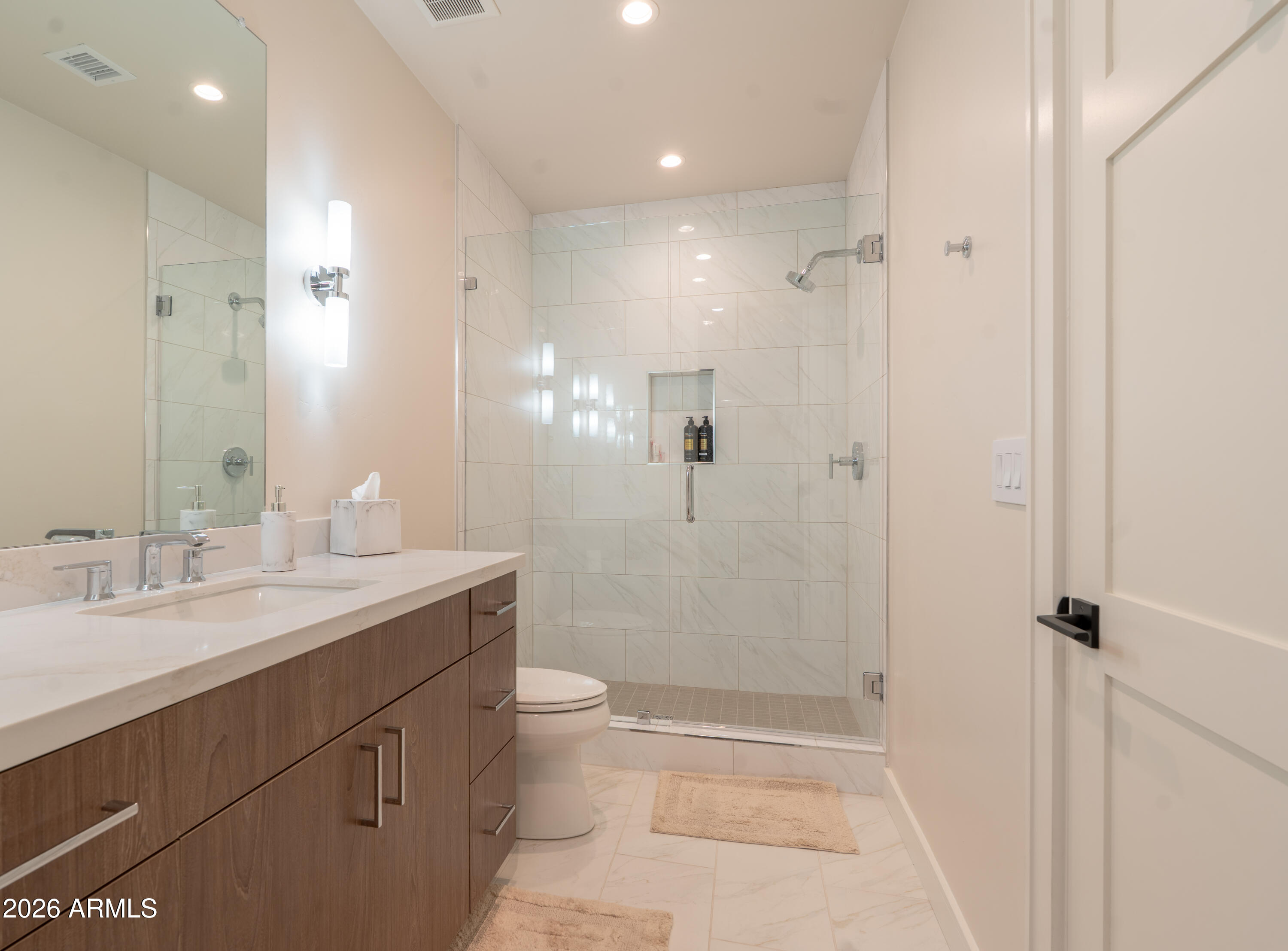 1733 East Bent Tree Circle, Unit 45 Flagstaff, AZ 86005 - Photo 18 of 37 a bathroom with a granite countertop sink a toilet and shower