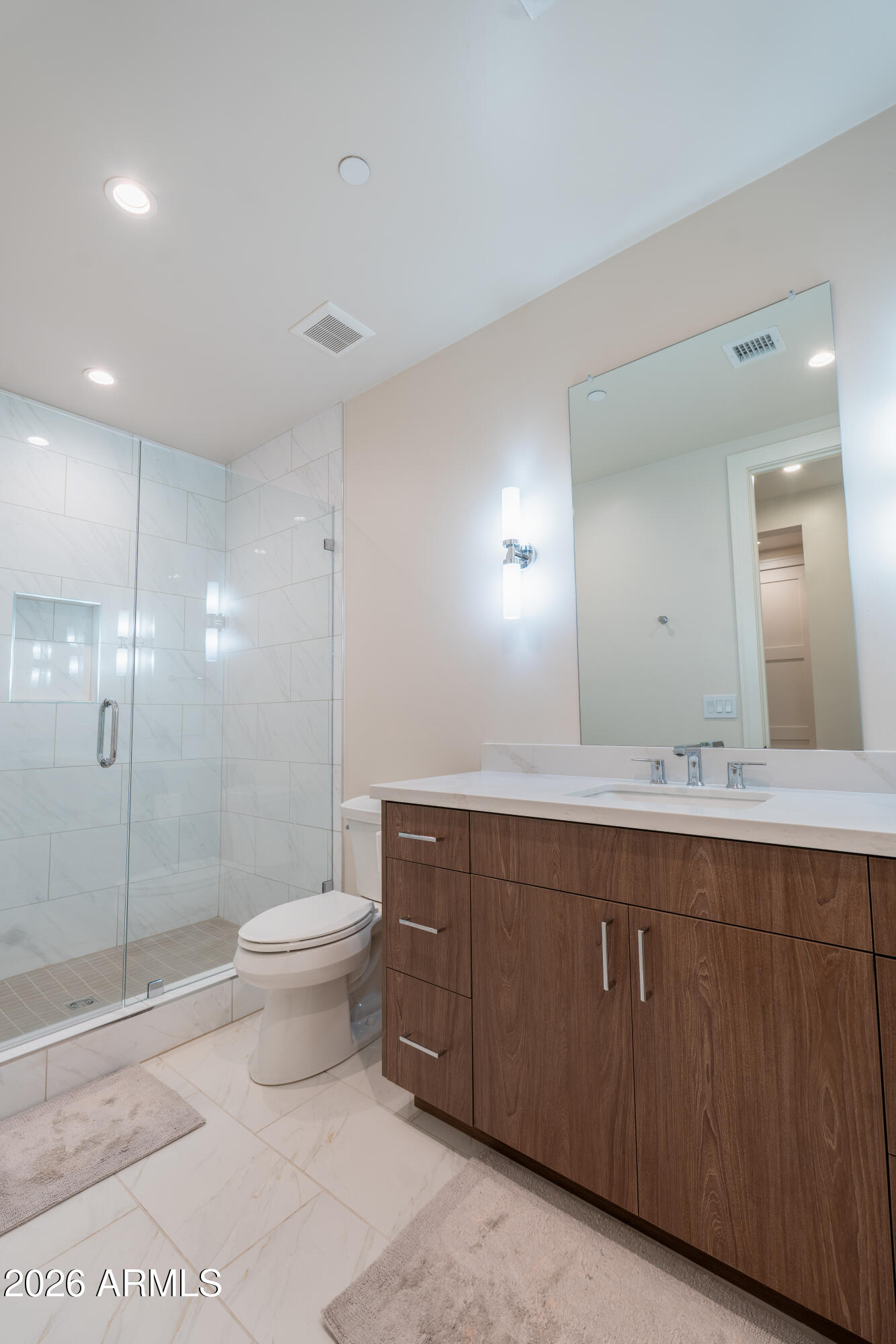 1733 East Bent Tree Circle, Unit 45 Flagstaff, AZ 86005 - Photo 21 of 37 a bathroom with a toilet sink and mirror