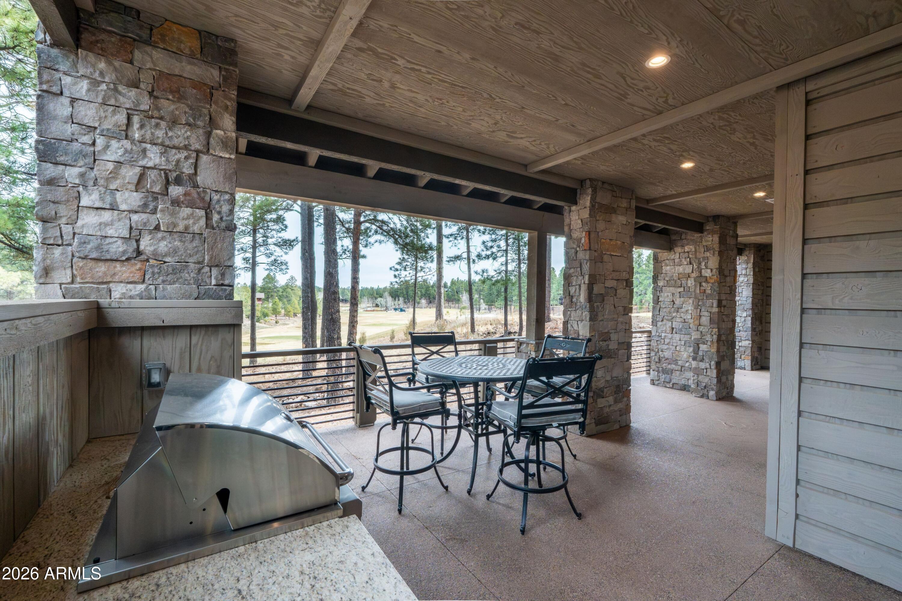 1733 East Bent Tree Circle, Unit 45 Flagstaff, AZ 86005 - Photo 23 of 37 a dining room with furniture and a floor to ceiling window