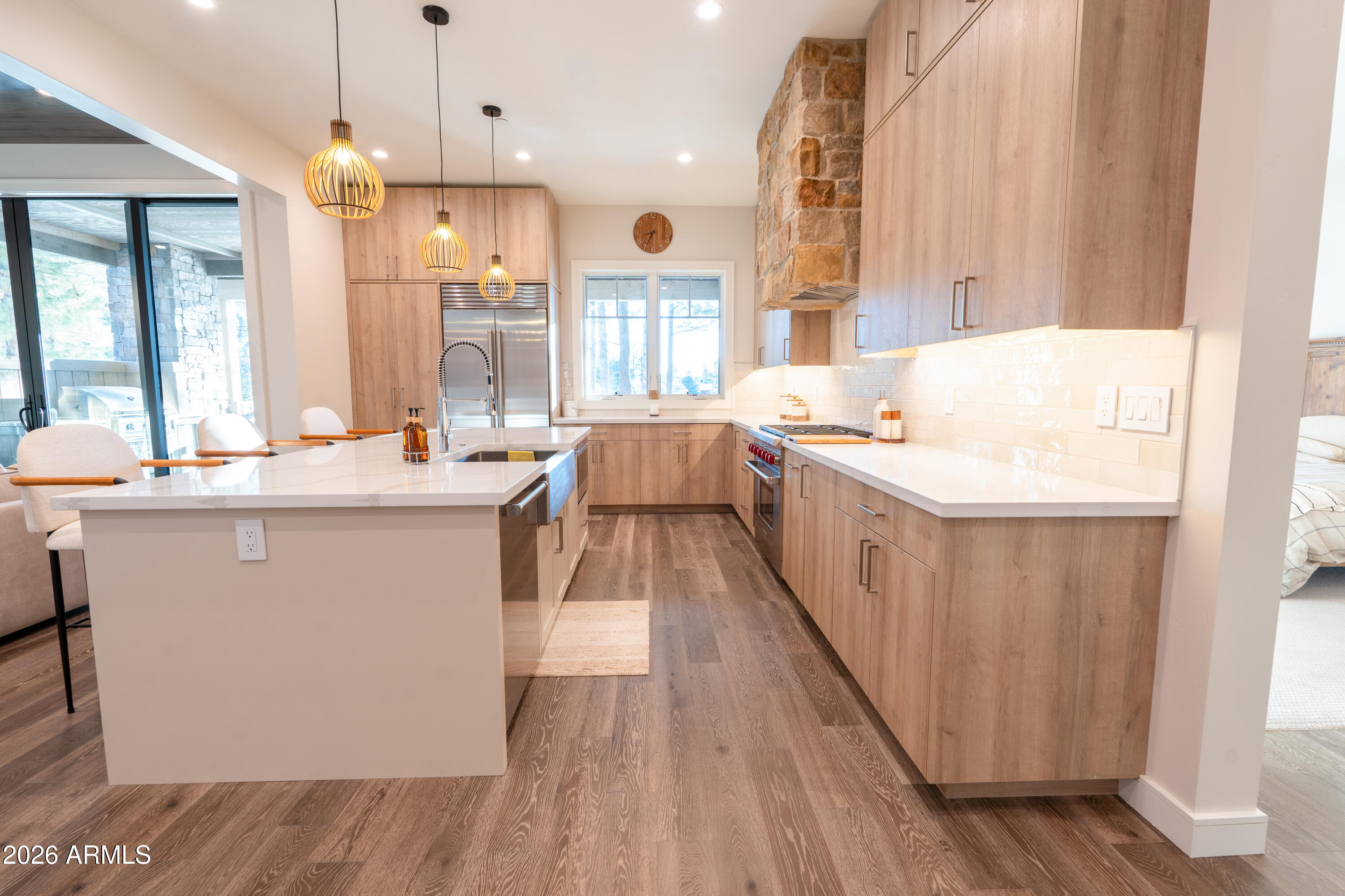 1733 East Bent Tree Circle, Unit 45 Flagstaff, AZ 86005 - Photo 4 of 37 a large living room with stainless steel appliances kitchen island granite countertop wooden floor and a large window