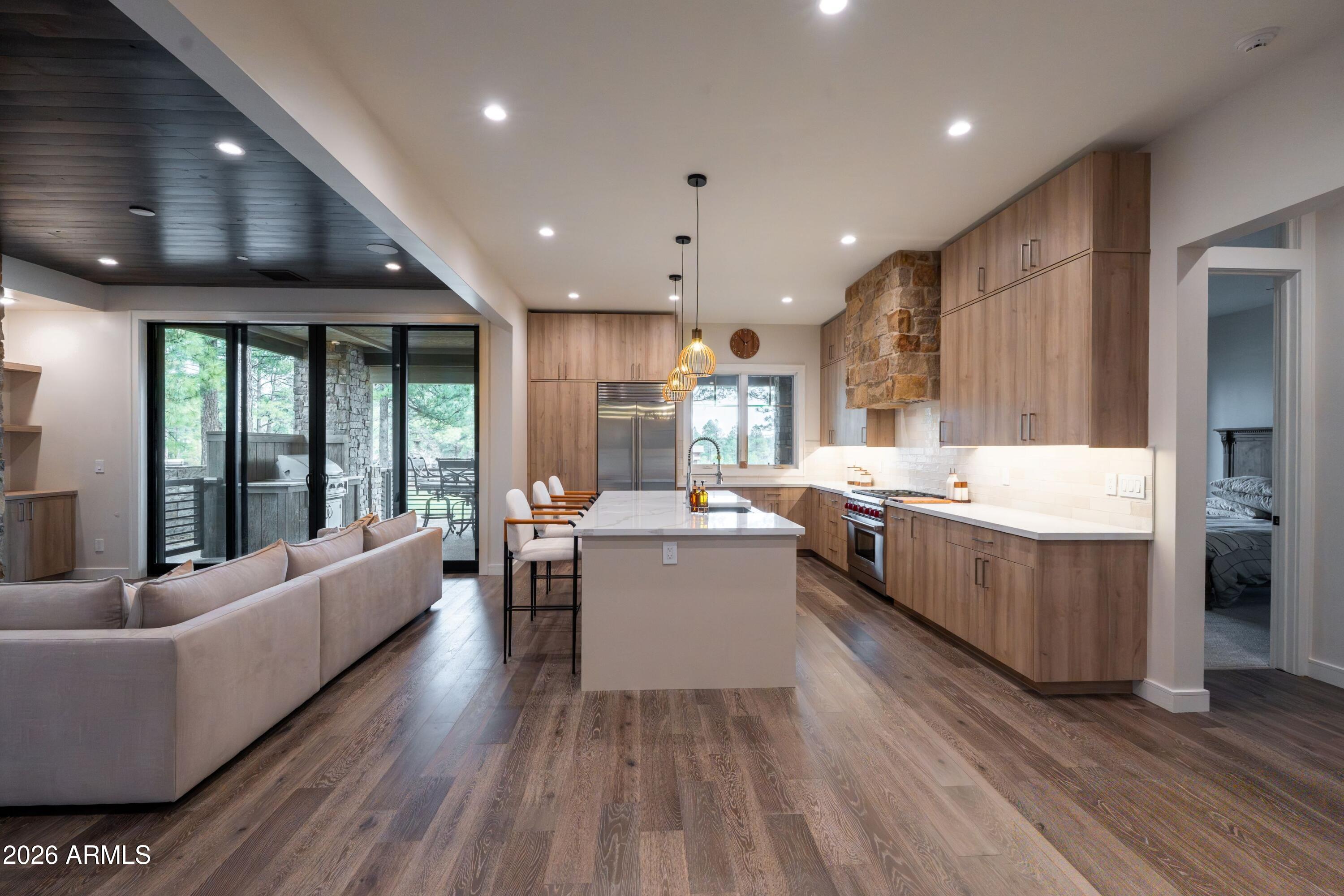 1733 East Bent Tree Circle, Unit 45 Flagstaff, AZ 86005 - Photo 5 of 37 a large white kitchen with a large window a sink and stainless steel appliances