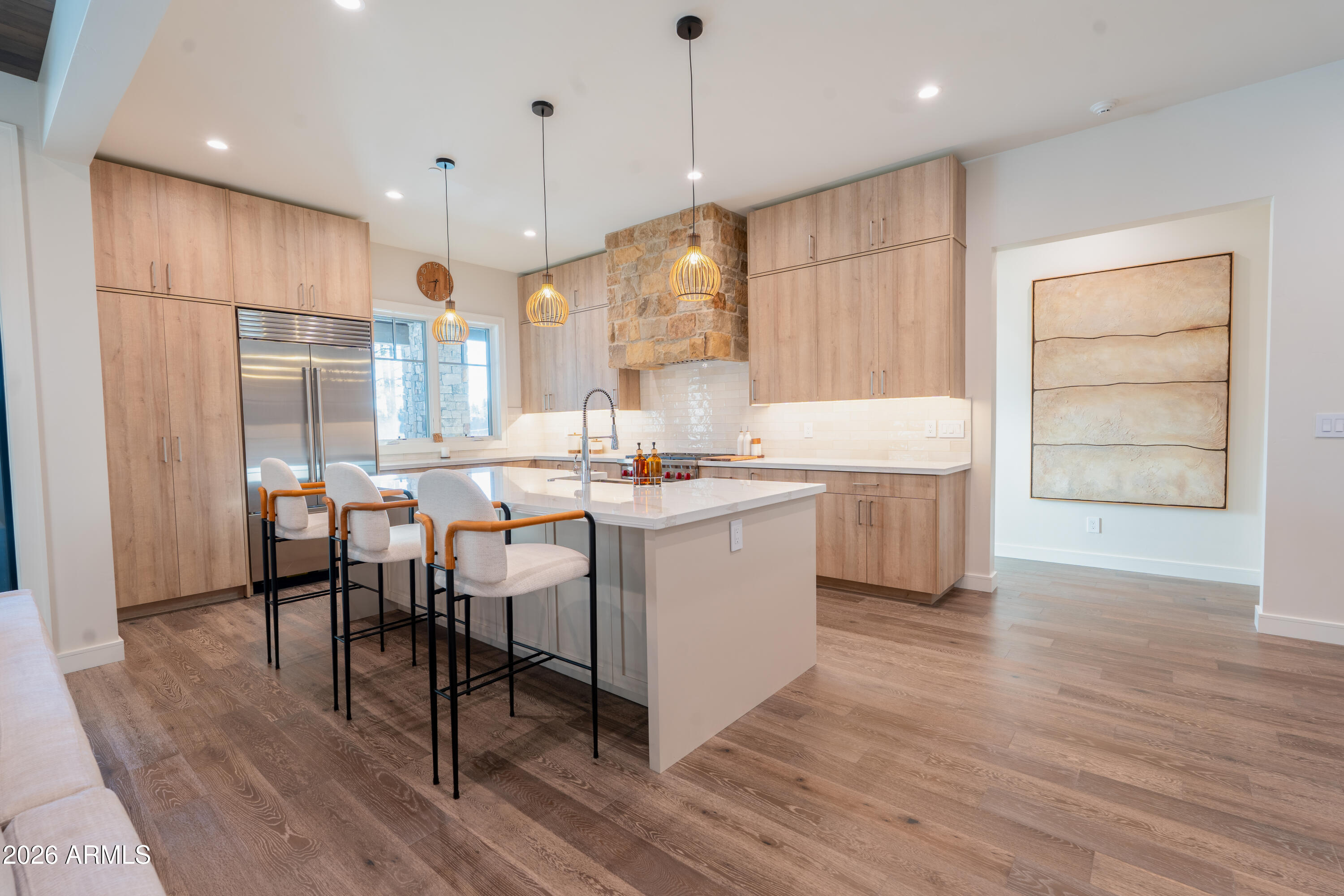 1733 East Bent Tree Circle, Unit 45 Flagstaff, AZ 86005 - Photo 9 of 37 a kitchen with a table chairs refrigerator and cabinets