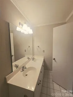 a bathroom with a sink a mirror and vanity