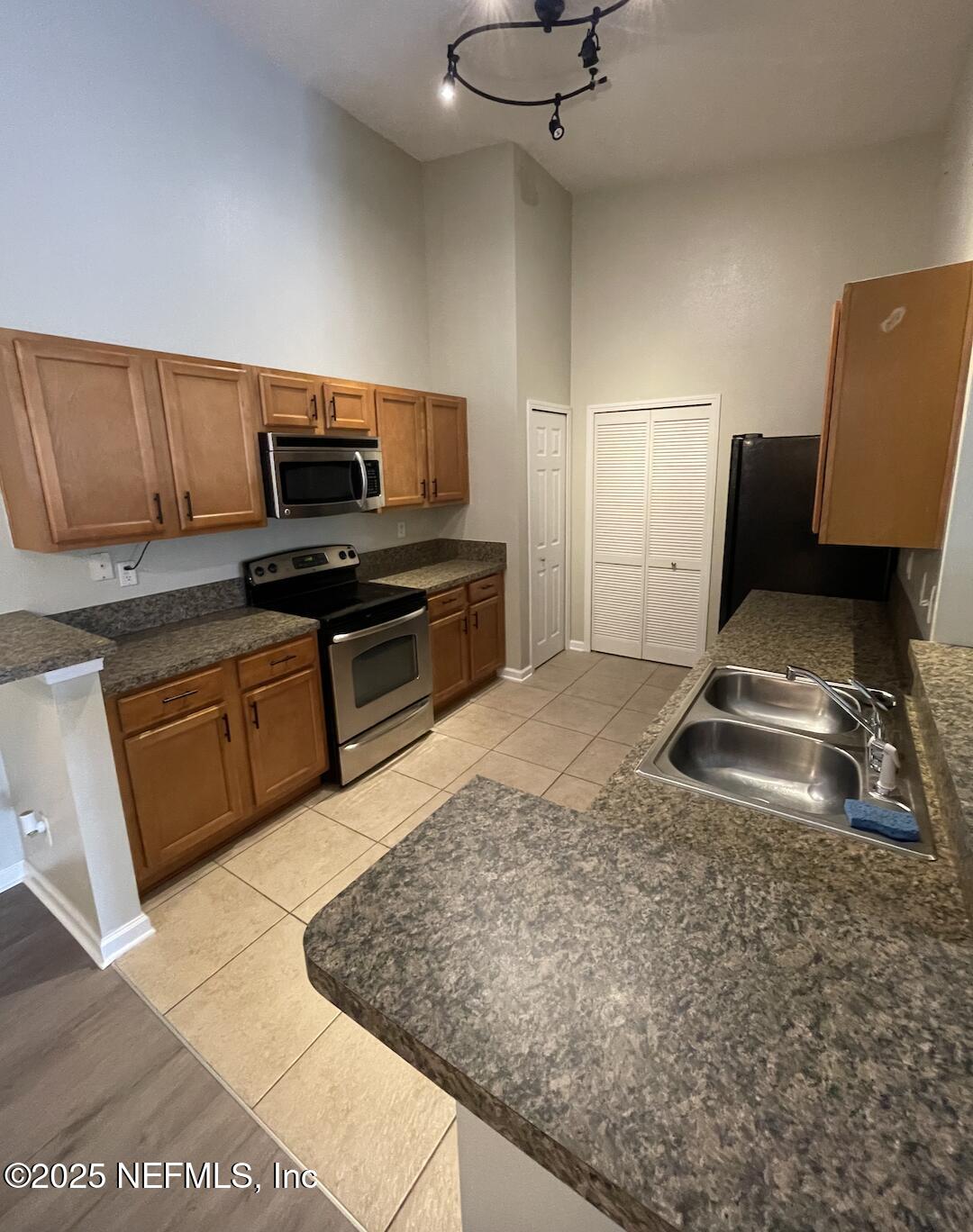 264 Golden Lake Loop, Unit 264 St. Augustine, FL 32084 - Photo 13 of 18 a kitchen with granite countertop a sink cabinets and stainless steel appliances
