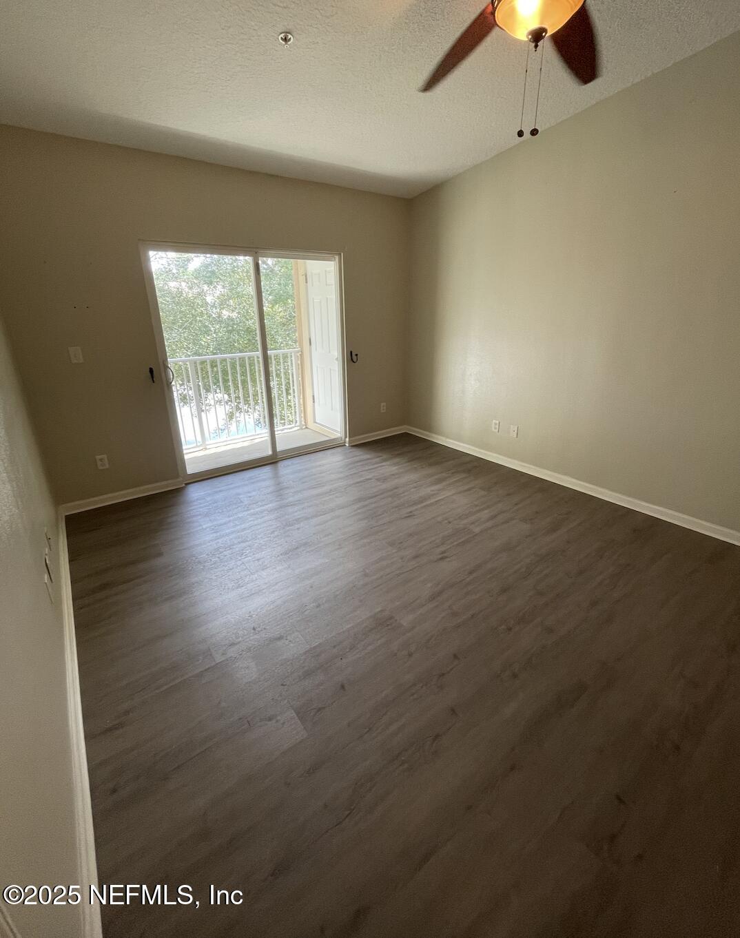 264 Golden Lake Loop, Unit 264 St. Augustine, FL 32084 - Photo 15 of 18 an empty room with a window and a chandelier fan