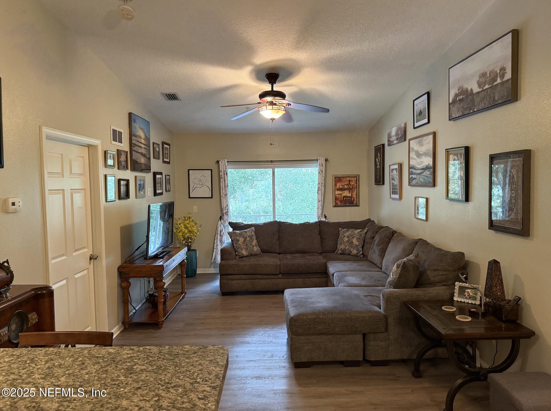 264 Golden Lake Loop, Unit 264 St. Augustine, FL 32084 - Photo 3 of 18 a living room with furniture and a flat screen tv
