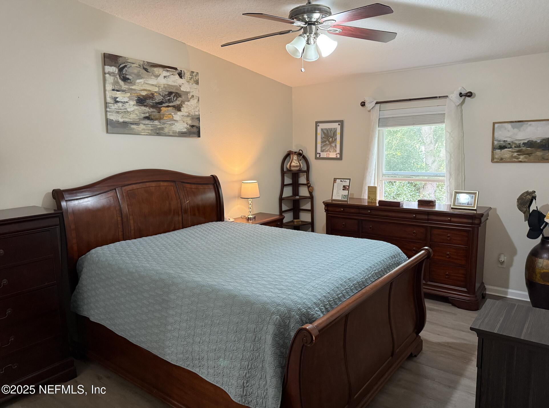 264 Golden Lake Loop, Unit 264 St. Augustine, FL 32084 - Photo 7 of 18 a bedroom with a bed and a chandelier