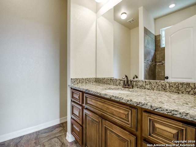 192 Weatherby Drive, Unit A Spring Branch, TX 78070 - Photo 18 of 25 a bathroom with a granite countertop sink and a mirror