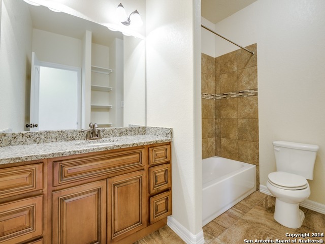 192 Weatherby Drive, Unit A Spring Branch, TX 78070 - Photo 22 of 25 a bathroom with a granite countertop sink toilet and shower