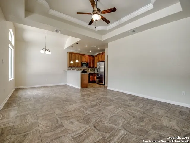a view of a kitchen with a sink and a refrigerator