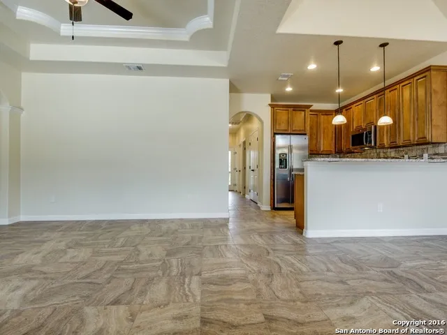 a view of a kitchen with a refrigerator and a sink