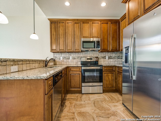 192 Weatherby Drive, Unit A Spring Branch, TX 78070 - Photo 9 of 25 a kitchen with stainless steel appliances granite countertop a stove a sink and a microwave