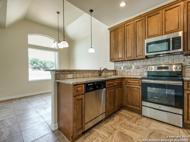192 Weatherby Drive, Unit A Spring Branch, TX 78070 - Photo 10 of 25 a kitchen with stainless steel appliances granite countertop a stove a sink and a microwave