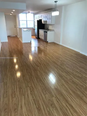 a view of kitchen and hall with wooden floor