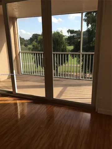 a view of a wooden deck with a yard