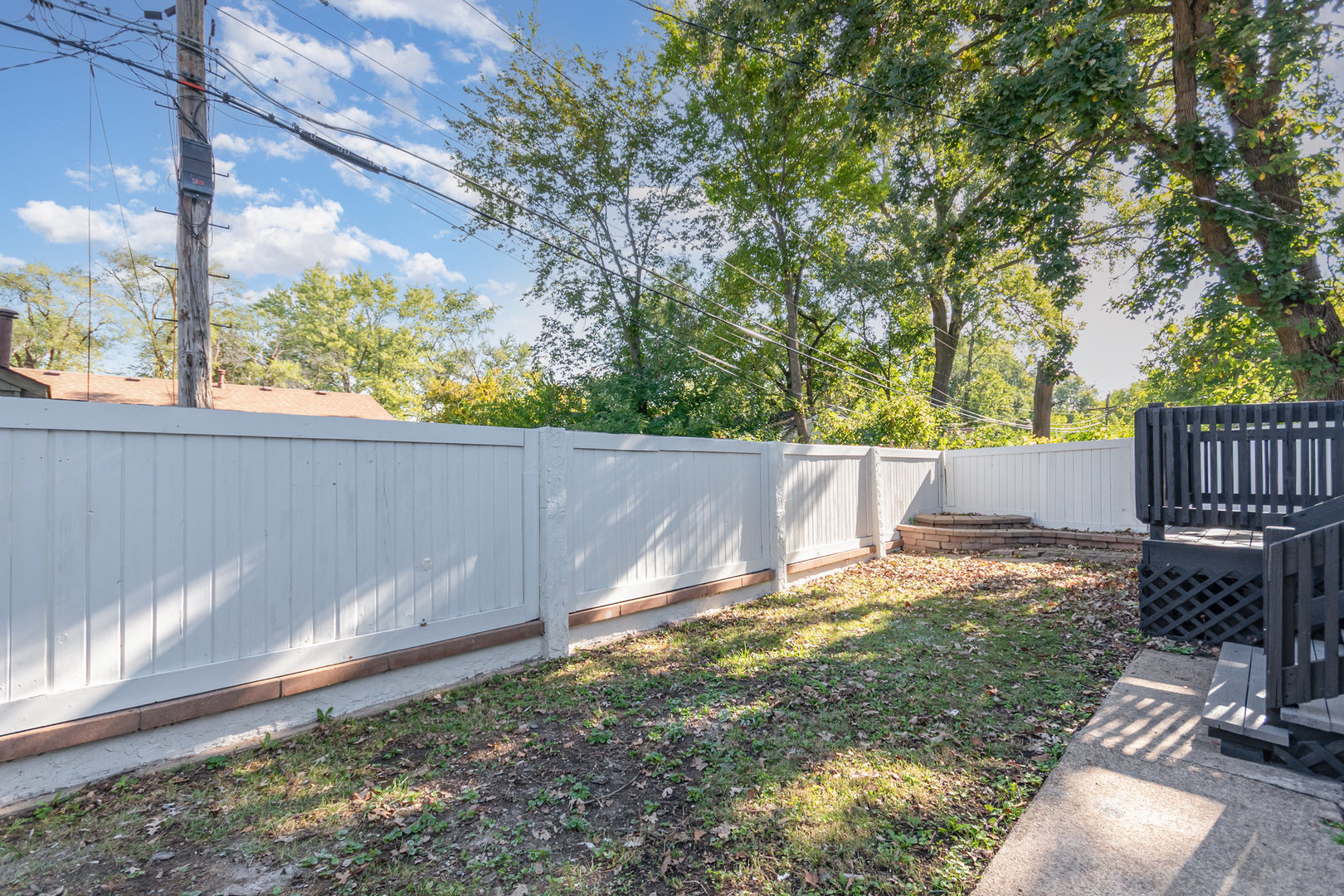 305 Luana Road Joliet, IL 60433 - Photo 15 of 16 a backyard of a house with table and chairs