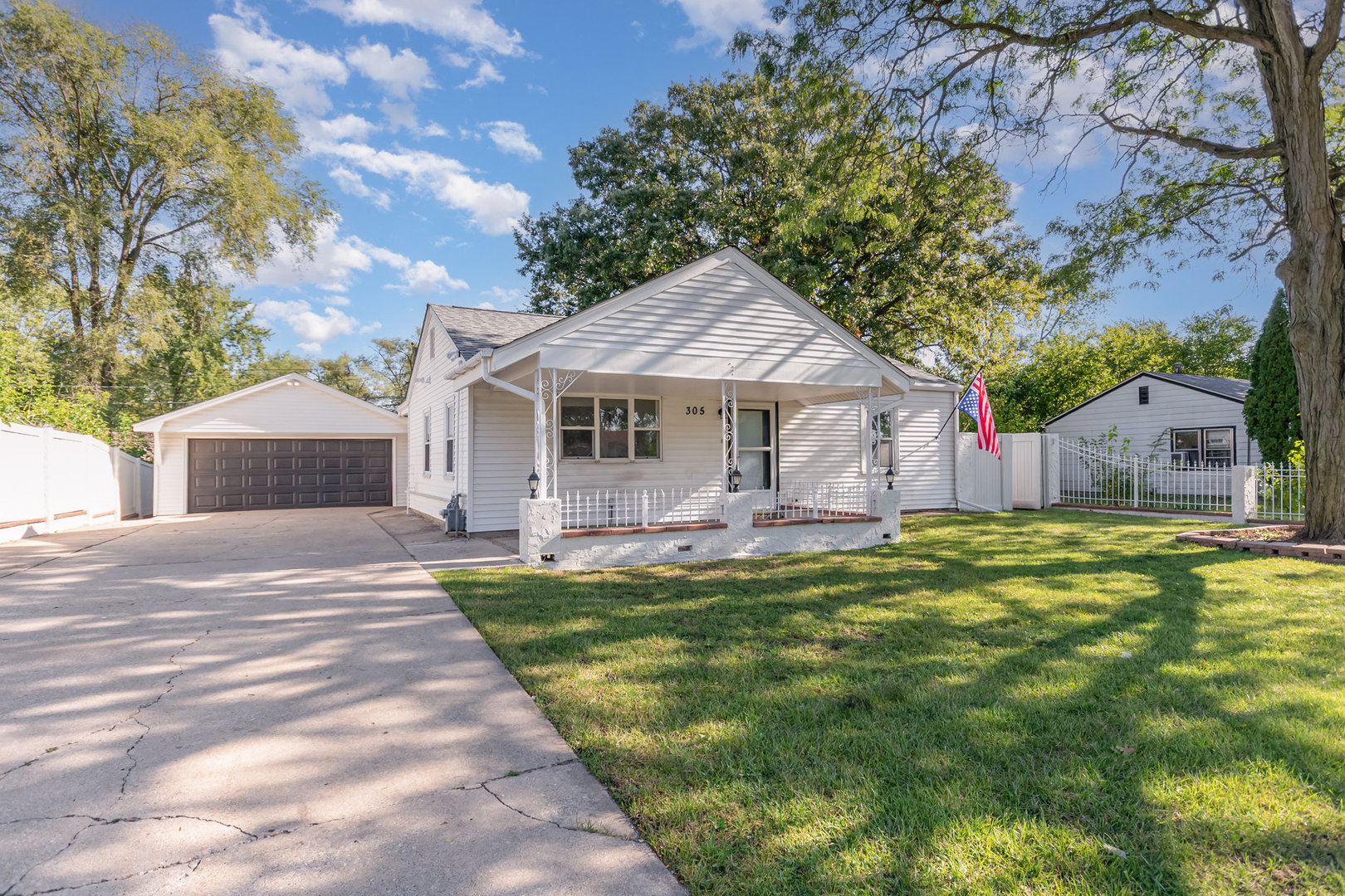 305 Luana Road Joliet, IL 60433 - Photo 2 of 16 a front view of a house with a garden and trees